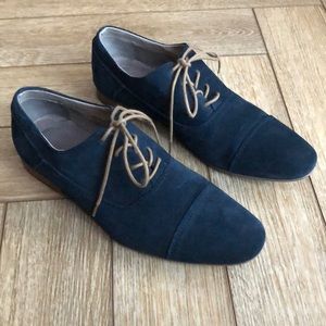 Calvin Klein navy suede dress shoes with tan laces.